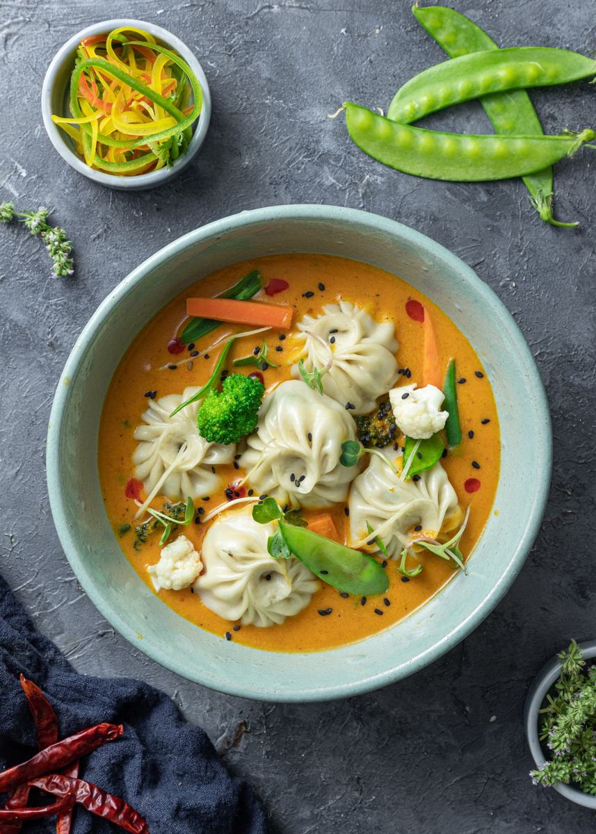 Jhol momos in a bowl of broth